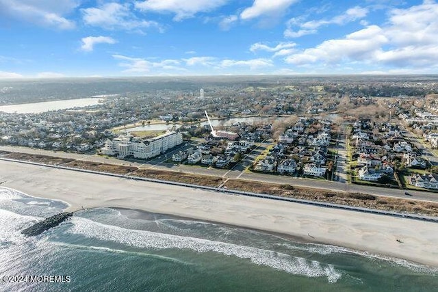 birds eye view of property featuring a view of the beach and a water view