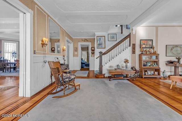 carpeted foyer entrance with ornamental molding