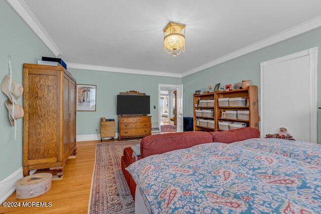 bedroom with light hardwood / wood-style flooring and crown molding