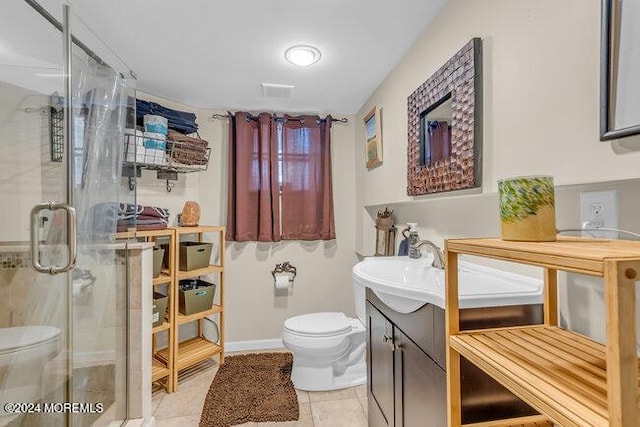 bathroom featuring tile patterned floors, vanity, toilet, and walk in shower