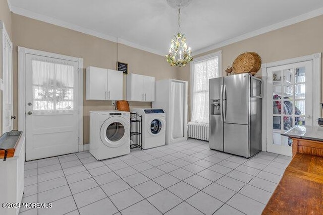 laundry area featuring radiator, light tile patterned flooring, washer and dryer, and ornamental molding