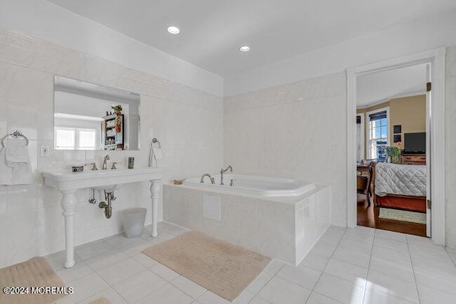 bathroom with plenty of natural light and tile walls