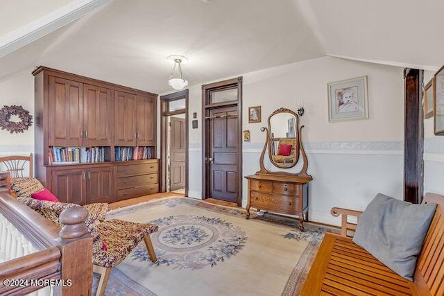 sitting room with light hardwood / wood-style flooring and lofted ceiling