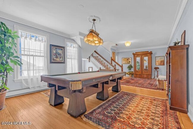 playroom with pool table, light hardwood / wood-style floors, a baseboard heating unit, and ornamental molding