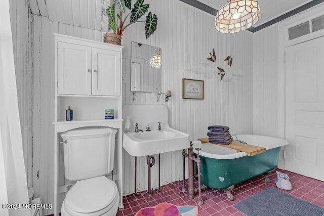 bathroom featuring toilet, a bathtub, and ornamental molding