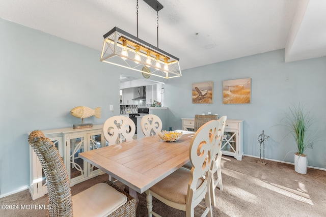 dining room featuring carpet floors and an inviting chandelier