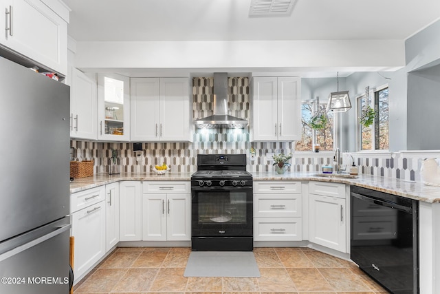 kitchen with black appliances, white cabinetry, wall chimney range hood, and sink