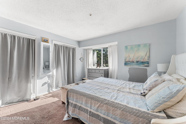 bedroom featuring carpet floors and a textured ceiling