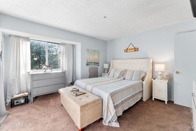 carpeted bedroom featuring a textured ceiling