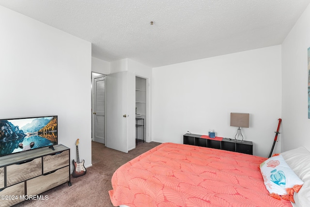 carpeted bedroom with a textured ceiling