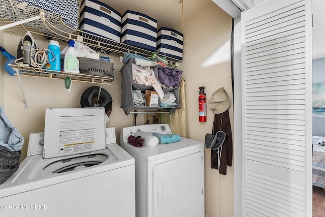 clothes washing area featuring washing machine and clothes dryer