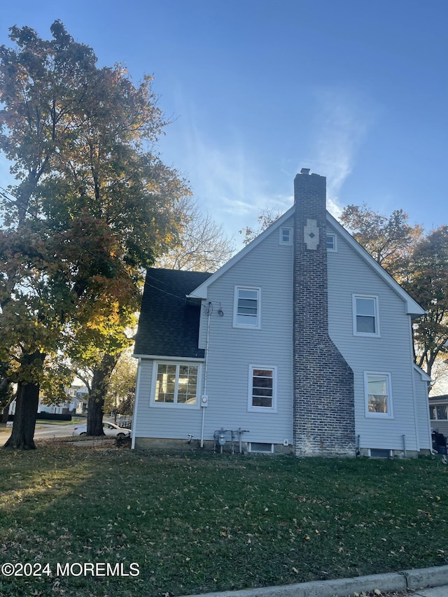 view of side of home featuring a yard