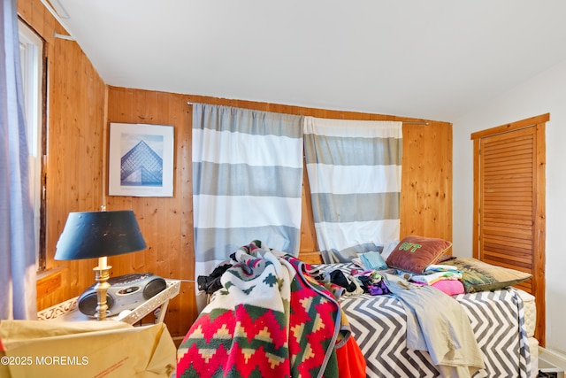 bedroom with wood walls and lofted ceiling