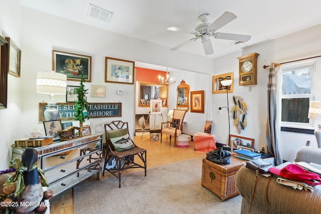 interior space featuring light parquet floors and ceiling fan with notable chandelier