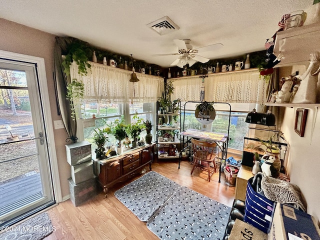 sunroom with a wealth of natural light and ceiling fan