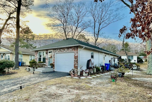 property exterior at dusk featuring a garage