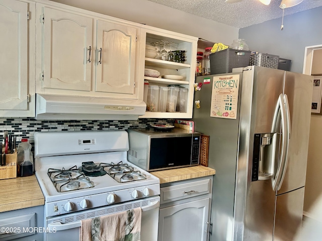 kitchen with white gas range, white cabinetry, stainless steel refrigerator with ice dispenser, a textured ceiling, and decorative backsplash