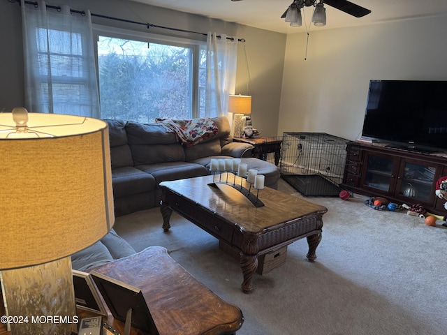 carpeted living room with ceiling fan