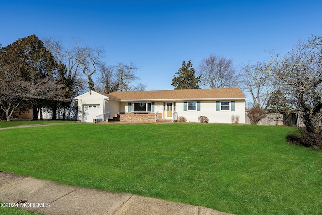 ranch-style home featuring a front lawn and a garage