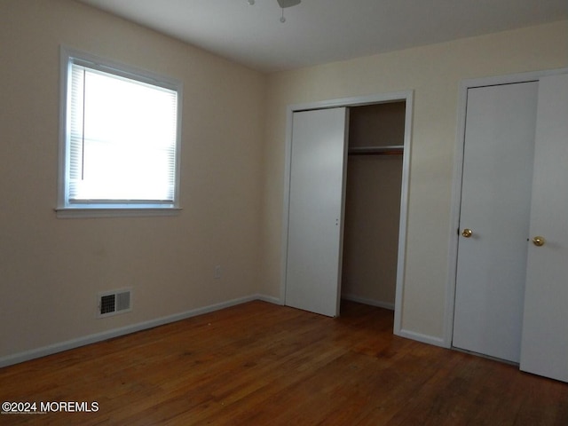 unfurnished bedroom featuring dark hardwood / wood-style flooring