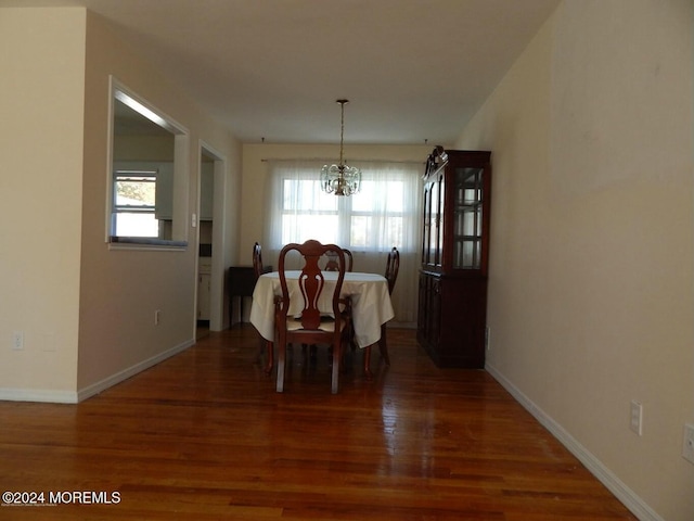 dining room featuring dark hardwood / wood-style flooring and a chandelier