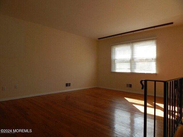 unfurnished room featuring hardwood / wood-style flooring