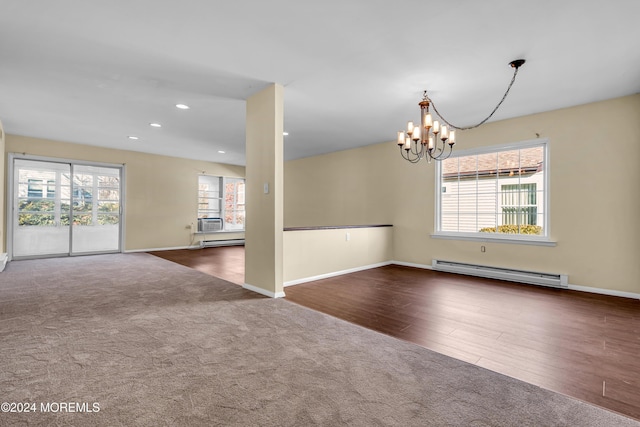 unfurnished room with plenty of natural light, dark hardwood / wood-style flooring, a chandelier, and a baseboard radiator