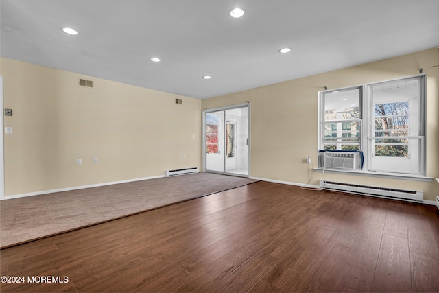 empty room with cooling unit, wood-type flooring, and baseboard heating