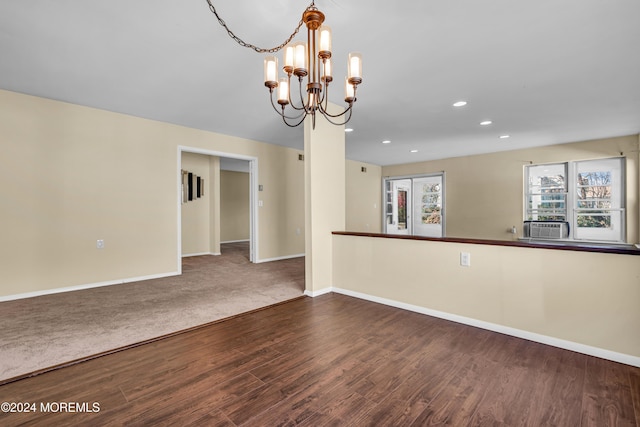 carpeted empty room with a chandelier