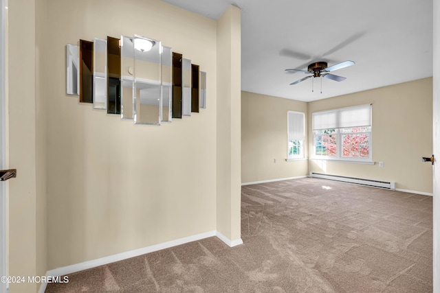 spare room with carpet flooring, ceiling fan, and a baseboard radiator