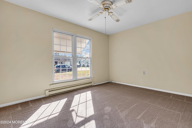 spare room featuring carpet, ceiling fan, and baseboard heating