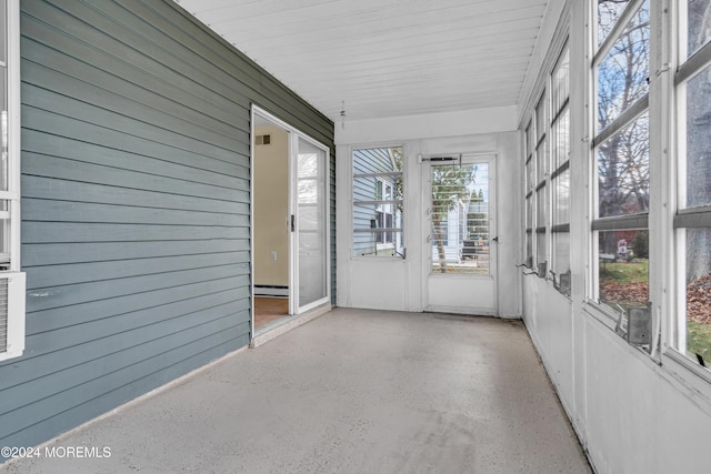 unfurnished sunroom with a wealth of natural light and a baseboard radiator