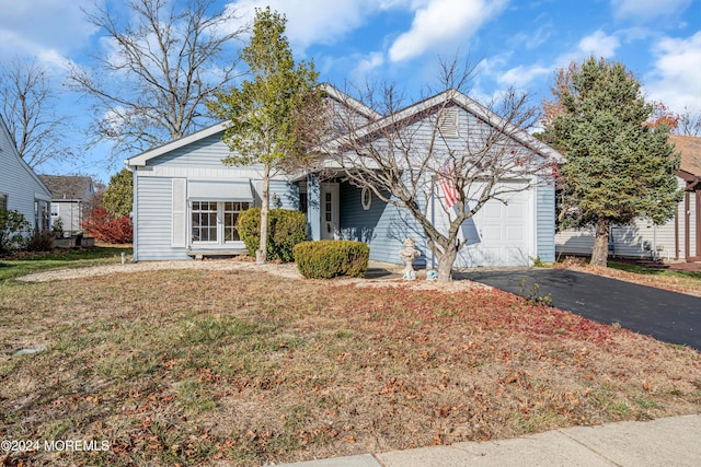 view of front of home with a front lawn and a garage