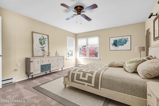 carpeted bedroom with ceiling fan and baseboard heating