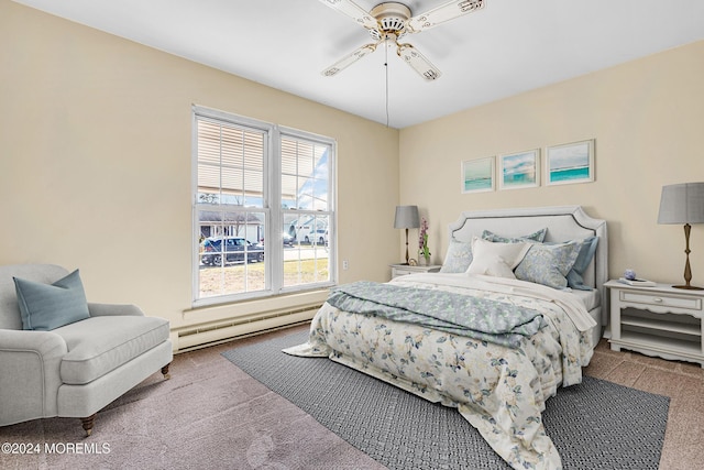 carpeted bedroom with baseboard heating and ceiling fan