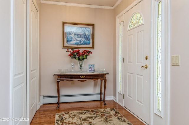 entryway with hardwood / wood-style flooring, crown molding, and a baseboard heating unit