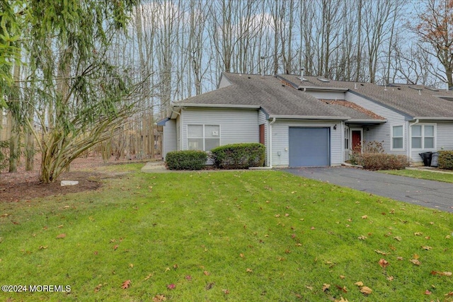 view of front facade with a front yard and a garage