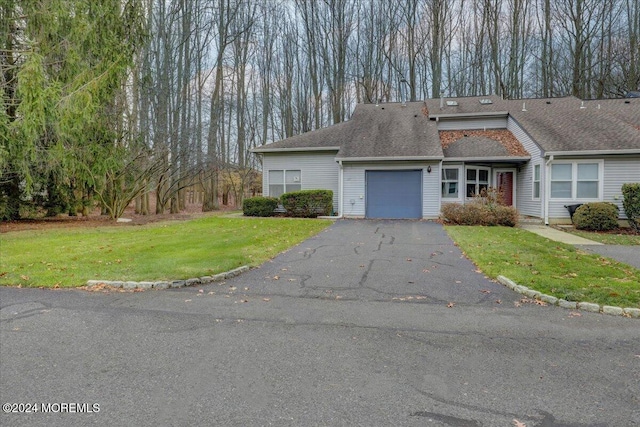 view of front of home with a garage and a front yard