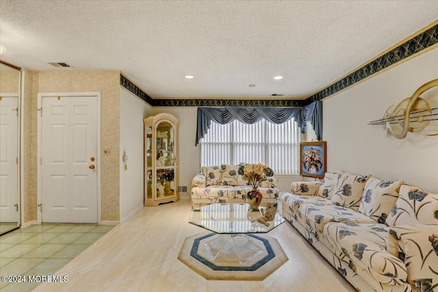 tiled living room featuring a textured ceiling