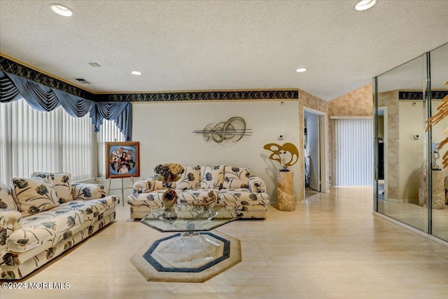 living room with hardwood / wood-style flooring and a textured ceiling