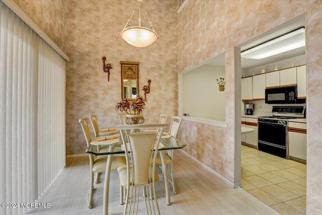 tiled dining space featuring a towering ceiling