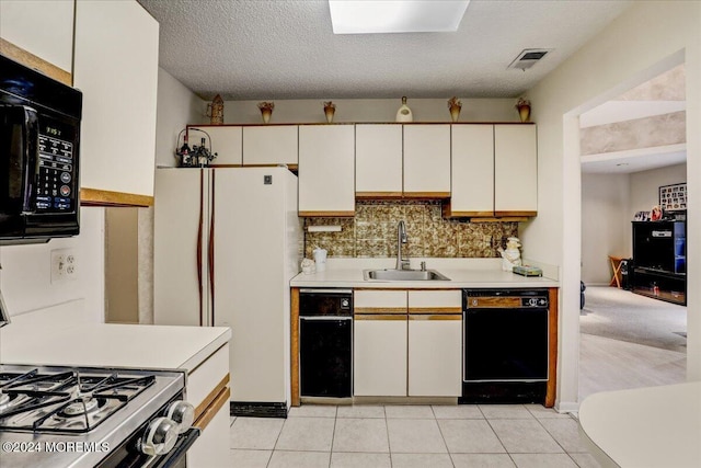 kitchen with sink, white cabinets, black appliances, and a textured ceiling