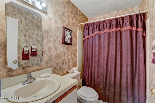 bathroom with curtained shower, vanity, a textured ceiling, and toilet