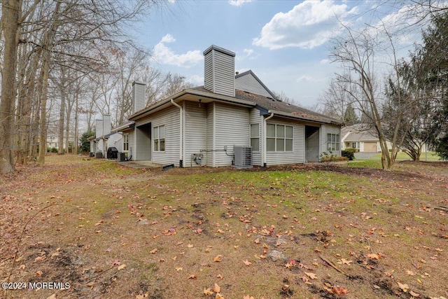 view of home's exterior with a yard and cooling unit