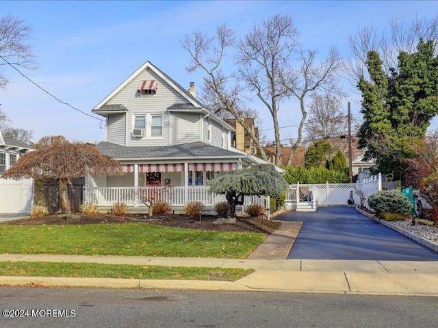 view of front of property with a porch and a front yard