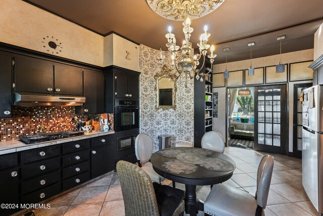 tiled dining space with french doors, a towering ceiling, and a notable chandelier