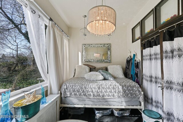 bedroom featuring a notable chandelier