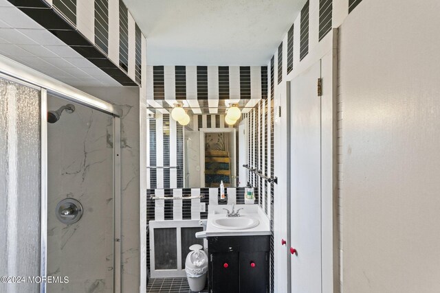 bathroom featuring vanity and a shower with door