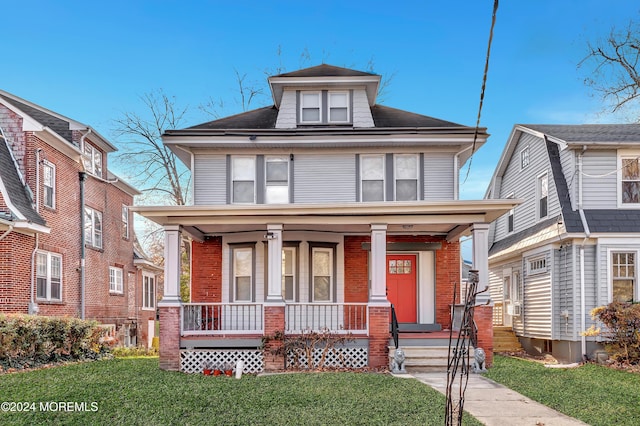 view of front facade with a porch and a front lawn