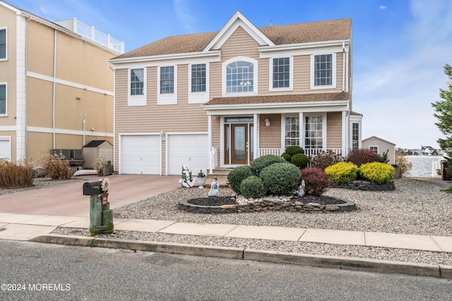 view of front of home with concrete driveway, roof with shingles, and an attached garage